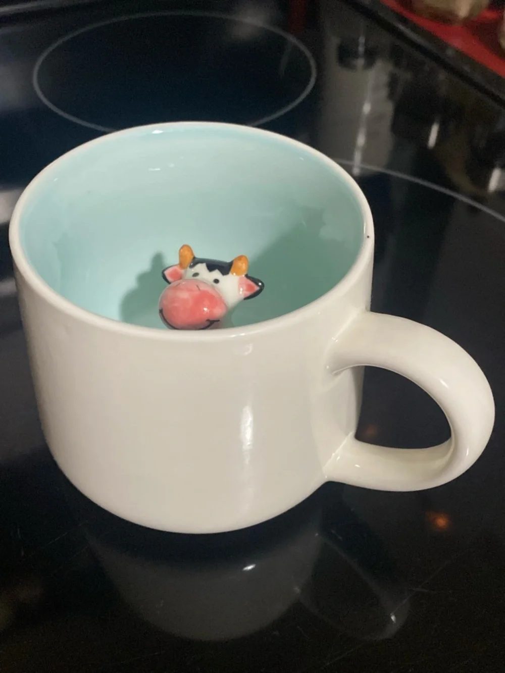 Peek-a-boo ceramic cow mug